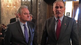 Washington state Sen. Reuven Carlyle, pictured on the left of Gov. Jay Inslee in this file photo, is sponsoring a sweeping data privacy bill this year