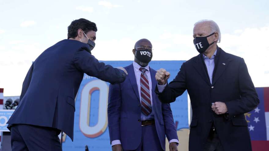 President-elect Joe Biden campaigns in Atlanta, Monday, Jan. 4, 2021, for Senate candidates Raphael Warnock, center, and Jon Ossoff, left. (AP Photo/Carolyn Kaster)