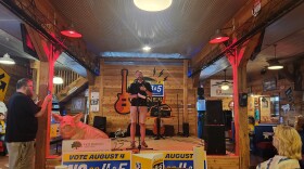 Micha Titterington, executive director of Community Outreach Ministries in Bolivar, speaks at a rally at Boone's BBQ Barn on July 28, 2026.