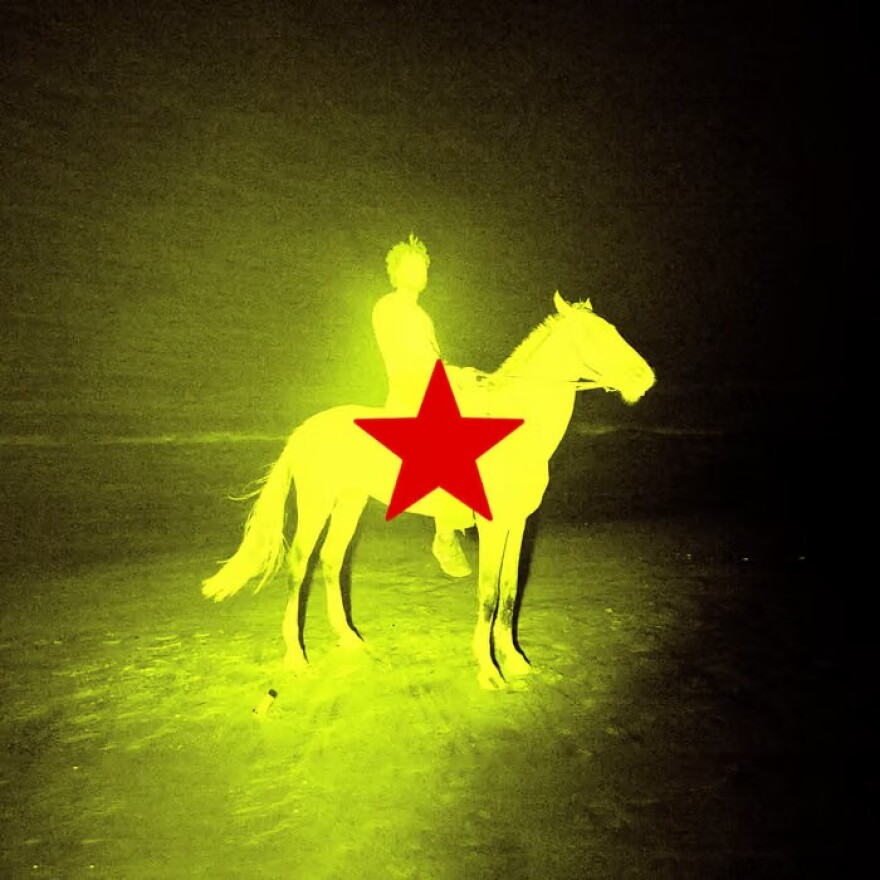 a yellow image of a man on a horse with a red star 