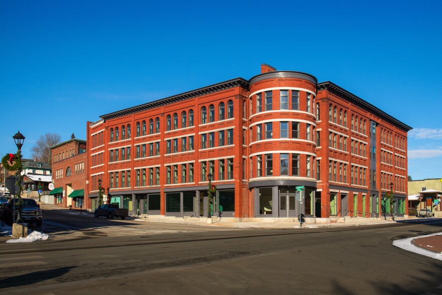 A four-story corner building on a city street