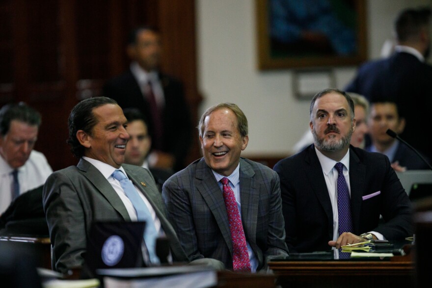 Texas Attorney General Ken Paxton, center, sits between defense attorneys Tony Buzbee, left, and Mitch Little, right, before starting the ninth day of his impeachment trial in the Senate Chamber at the Texas Capitol on Friday, Sept. 15, 2023, in Austin, Texas.<br/>