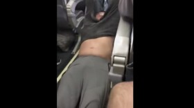 This Sunday, April 9, 2017, image made from a video provided by Audra D. Bridges shows a passenger being removed from a United Airlines flight in Chicago. (Audra D. Bridges via AP)