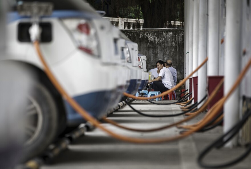 A row of BYD electric taxis are charged up at the company's charging station in Shenzhen.