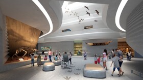 A computer rendering of a brightly lit lobby area of a museum, with people walking around looking at the various exhibits.