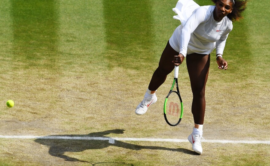 Serena Williams of The United States serves against Julia Goerges of Germany during their Ladies' Singles semi-final match on day 10 of Wimbledon on July 12, 2018 in London.