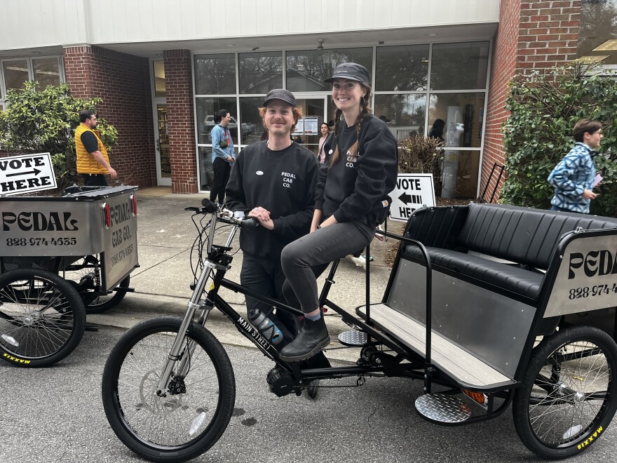 Tyler and Andy Roach of Pedal Cab Co. offered voters free rides home from the poll at the West Asheville Library.