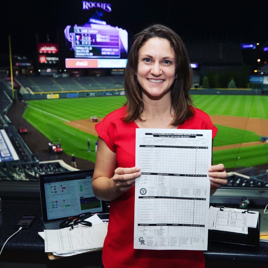 Jillian Geib shows off a scorecard at Coors Field to celebrate her new role as an official scorekeeper for the Colorado Rockies.