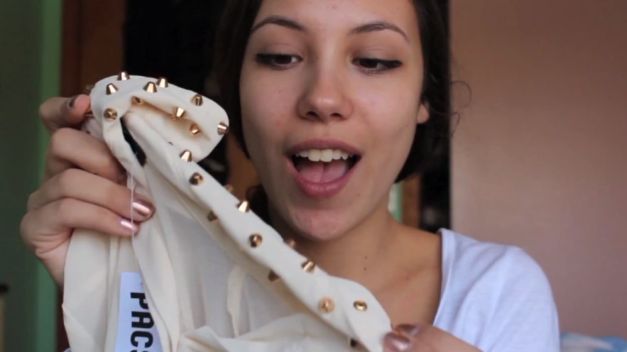 Abigail Moscaritolo holds up a recent fashion find on a "haul video." The YouTube trend has become so popular that fashion retailers are approaching haulers to promote their products online.