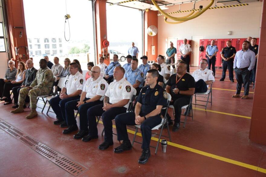 Arsenal Island firefighters and others attend the signing ceremony.