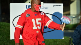 William Sanders, 44, finishes posing for a selfie with an "I voted. Will you" sign provided by the League of Women Voters at Arrowhead Stadium on Tuesday. Sanders said this was his first time voting and described it as "the most awesome experience ever."