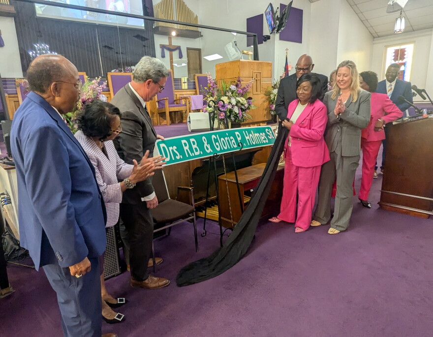 Local government officials joined the honorees in unveiling the new street sign.
