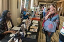 Garicka Hill, left, co-founder of PLPG Publishing, talks with Sammy Herzberg, director of the Oskaloosa Public Library during the Kansas Library Association's annual conference in Wichita.