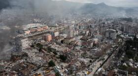 Smoke billows from the scene of a collapsed buildings on Feb. 07, 2023 in Hatay, Turkey. A 7.8-magnitude earthquake hit near Gaziantep, Turkey, in the early hours of Monday, followed by another 7.5-magnitude tremor just after midday. The quakes caused widespread destruction in southern Turkey and northern Syria and were felt in nearby countries.  (Burak Kara/Getty Images)