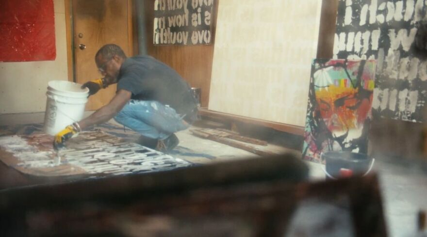 RISD Alum John Cox works in his studio in a scene from "Reframing Paradise." John founded the FUZE art fair which showcases the work of artists from across the Caribbean