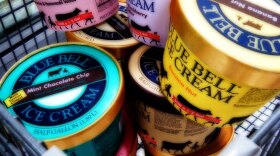 Several cartons of Blue Bell Ice Cream in a shopping cart