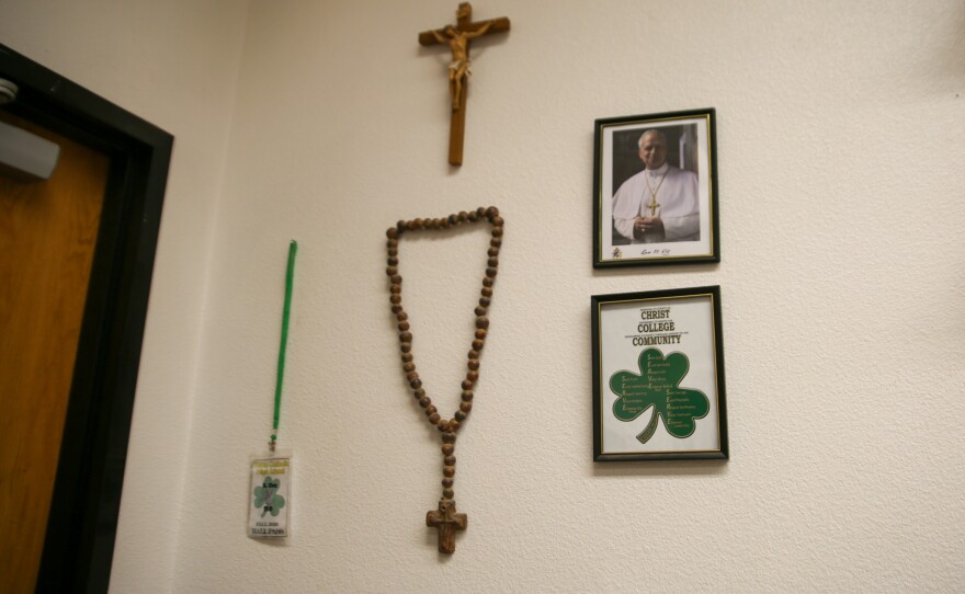 "Christ, College, Community" reads a framed image inside the chorale classroom.