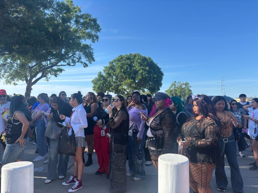 fans stand in the crowd outside of Raymond James Stadium 