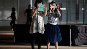 Children play with camera phones. (Paula Bronstein/Getty Images)