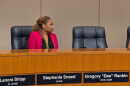 Woman at dais in pink jacket
