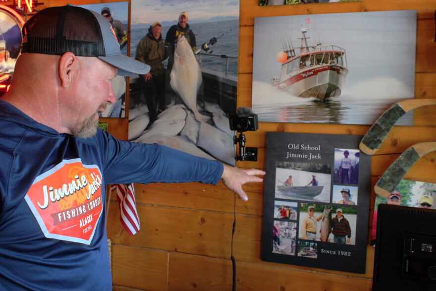 Jimmie Jack Drath points to family fishing photos inside his office on Monday, Aug. 17, 2026 in Soldotna, Alaska.