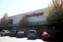 Cars parked in front of a grocery store called Fred Meyer.