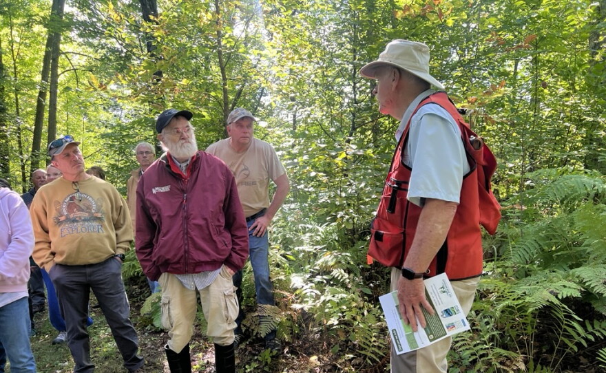 Gary Anderson speaks to a crowd touring his property Sept. 12 near Outing. 
