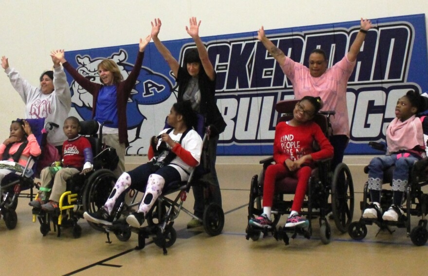 Teachers help these Ackerman students to do the spins and turns of this reindeer routine. 