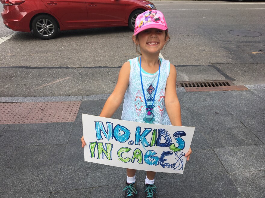 Little girl from Columbus with sign she made