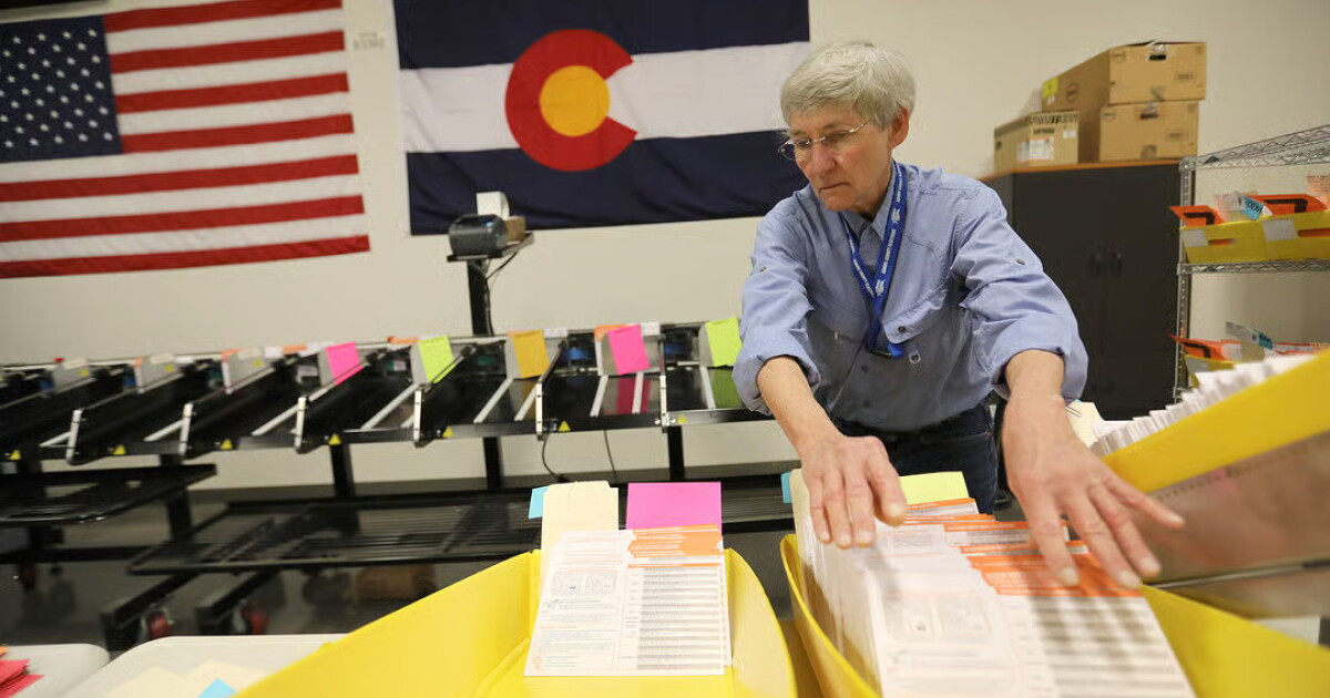 Photo: kunc.org Election workers sort and manage ballots at the Adams County Government Center in Brighton on Tuesday, March 3, 2020