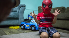 In this July 26, 2018 photo, a four-year-old boy is shown playing in a Spiderman mask, who is being cared for by Evelyn Zepeda at her home in Austin, Texas. 