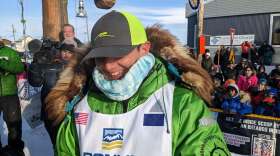 a man smiles at finish line