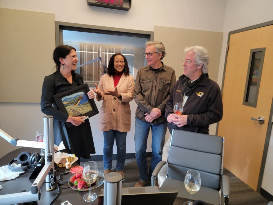 Southern Oregon University Laboratory of Anthropology Director Chelsea Rose (L) holds the 2022 Oregon Heritage Excellence Award won by SOULA and Jefferson Public Radio. She is joined by (L to R) Jefferson Exchange producers Angela Decker and John Baxter, and JX host Geoffrey Riley.