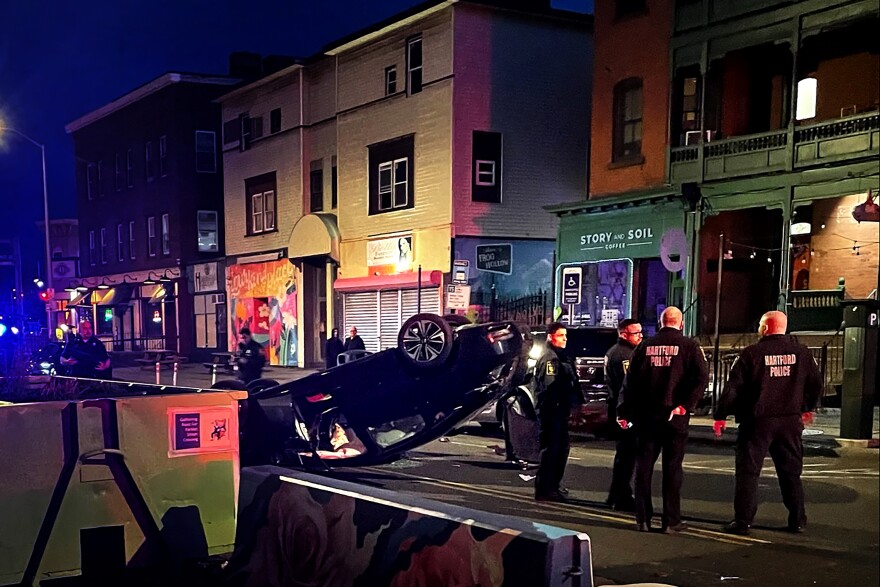 State Rep. Robin Comey's overturned car after a crash near the state Capitol in Hartford. The representative was arrested on charges of drunk driving at the scene.