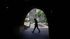 A pedestrian uses a tunnel walkway at the University of North Carolina in Chapel Hill, N.C., Tuesday, June 30, 2020.