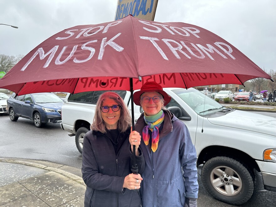 Two women under an umbrella.