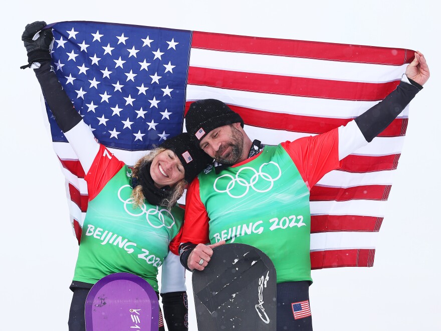 ZHANGJIAKOU, CHINA - FEBRUARY 12: Gold medallists Lindsey Jacobellis (L) and Nick Baumgartner of Team United States celebrate during the Mixed Team Snowboard Cross Finals flower ceremony on Day 8 of the Beijing 2022 Winter Olympics at Genting Snow Park on February 12, 2022 in Zhangjiakou, China. (Photo by Cameron Spencer/Getty Images)
