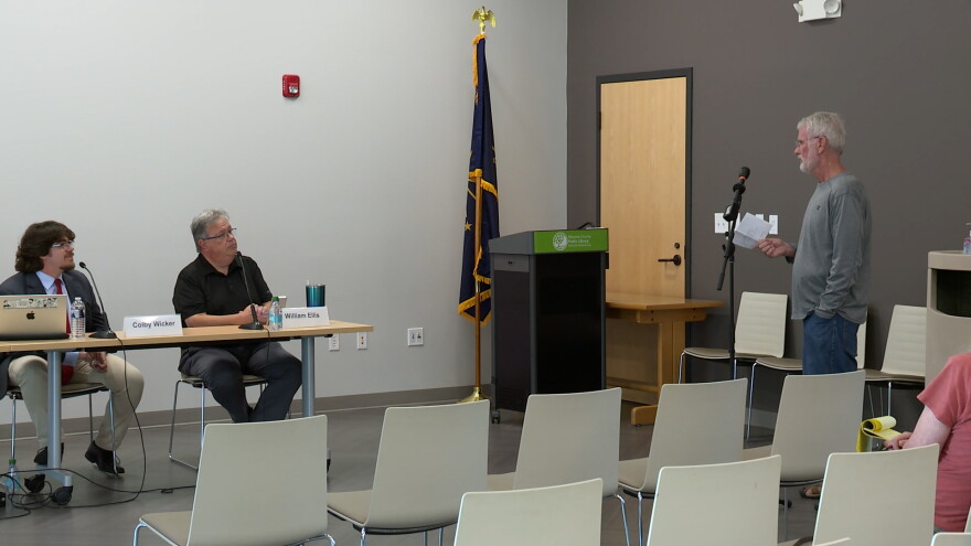 A man asks questions to a panel of experts.