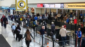 Travelers advance through the security line at Baltimore/Washington International Thurgood Marshall Airport in Baltimore, Monday, March 23, 2026. (AP Photo/Stephanie Scarbrough)