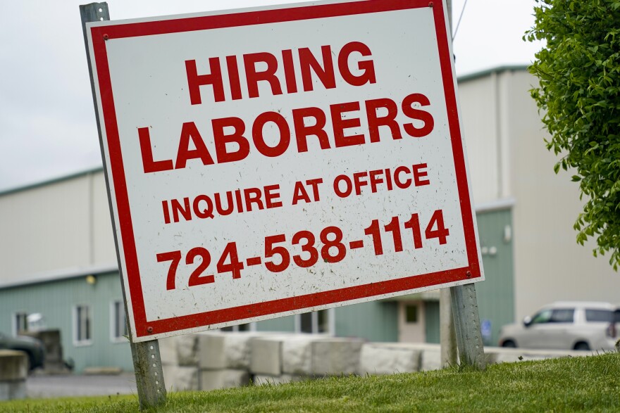 A sign seeking to hire laborers is posted outside a concrete products company in Evans City, Pa., Wednesday, May 5, 2021. A bill by Pennsylvania's Republican-controlled Legislature to reinstate work-search requirements for people claiming unemployment benefits cleared the House Labor and Industry Committee on a party-line vote Tuesday. Labor and Industry Committee Chairman Jim Cox, R-Berks, contends that employers are having trouble finding workers, and that they often blame the additional $300 per week in federal unemployment benefits during the pandemic and the lack of a work-search requirement. (AP Photo/Keith Srakocic)