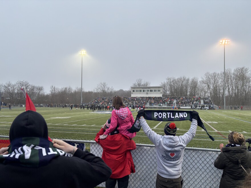 Hearts of Pine fans hold up scarves as they await kickoff of the teams first ever game.