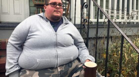 A Rochester, N.Y., native sits on his porch right before going to a name and gender change legal clinic hosted by the Empire Justice Center. (Karen Shakerdge/WXXI)