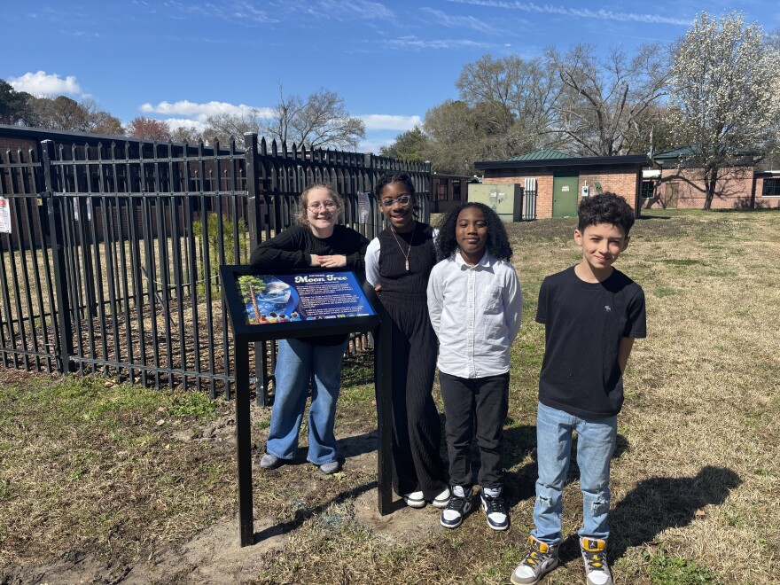 Fifth-graders Annabelle, MaKayla, Caiden and Levi in front of the moon tree at Mary W. Jackson Elementary School on March 18, 2026.