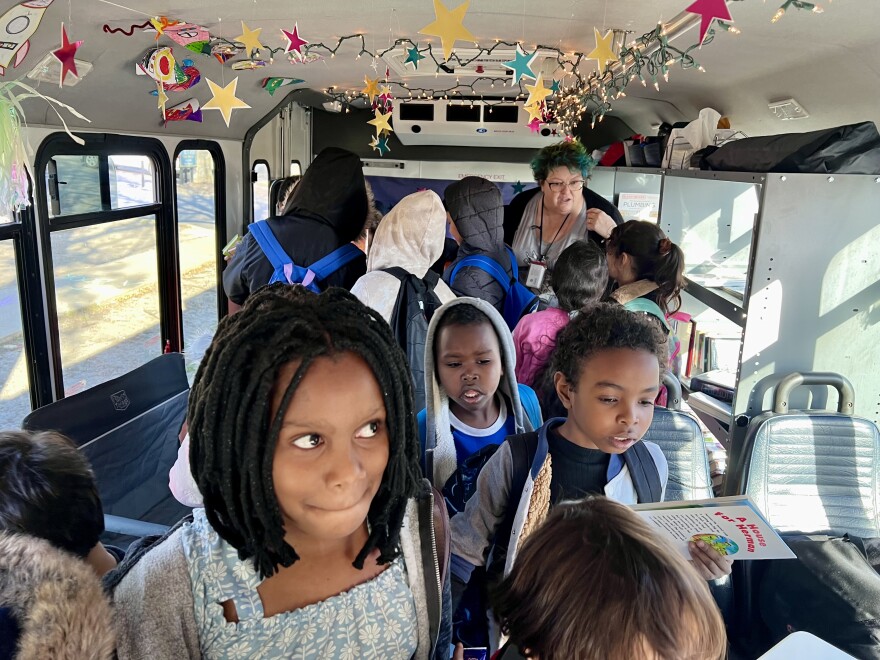 During a stop near Boston Park in southeast Wichita, dozens of elementary school students hopped aboard the book bus to borrow books and get snacks.