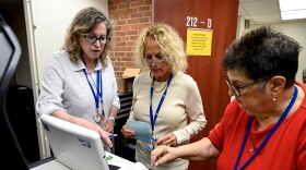Left to right: Democratic Deputy Registrar of Voters Sharon Fiarman, Democratic Registrar of Voters Deborah Greenberg, and Republican Registrar of Voters Francesca Signore, test a tabulator, a machine that counts paper ballots at Westport Town Hall on July 21, 2026.