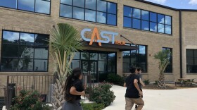 Students run past CAST Tech High School, one of San Antonio ISD's new specialized schools in May 2018.