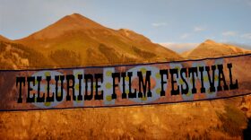 A banner hangs over Main street on opening day of the 28th Telluride Film Festival in Telluride, CO.