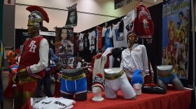 A booth filled with merchandise for Tommy Wiseau and 'The Room'