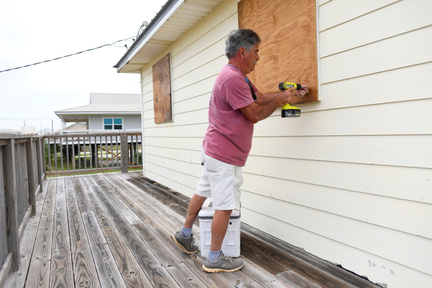Larry Smith boards up his home with plywood ahead of Hurricane Isaias' expected landfall along the Gulf Coast in Dauphin Island, Alabama, Thursday, Oct. 8, 2026. (AP Photo/Octavio Jones)
