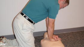 CPR Instructor Walt Blackburn demonstrates the proper way to perform chest compressions.